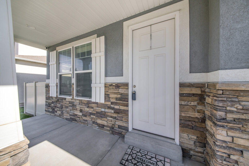 Exterior of a house with gray and stone veneer siding