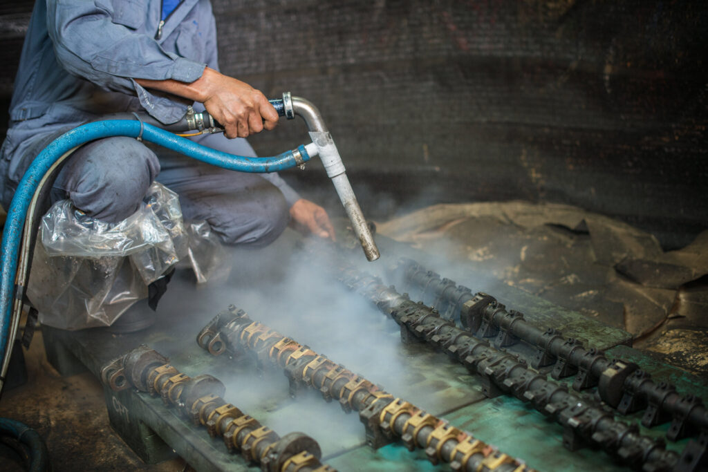 Worker is cleaning the machine