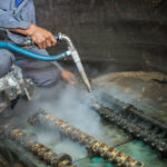 Worker is cleaning the machine